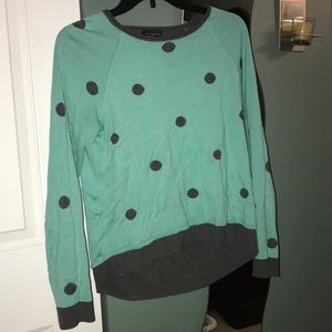 Long-sleeve polka dot shirt.